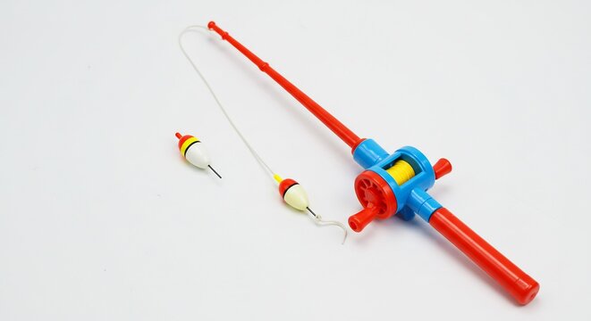 Brightly colored plastic fishing rod gleams under soft studio lighting. AI Generated