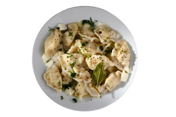 Delicious handmade dumplings served with creamy sauce and herbs at a cozy dining table