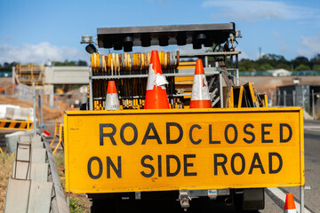 Road closed on side road sign near construction site