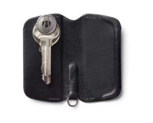 black leather wallet with keys on transparent 