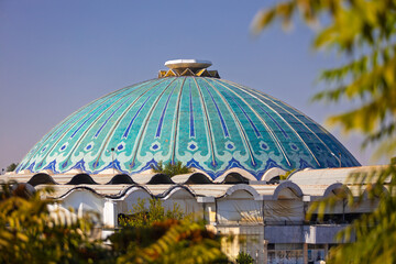 View on turquoise main dome of the Chorsu bazaar or Eski juva bazaar at Tashkent, Uzbekistan. Blurred foreground