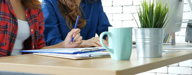 Banner Happiness two women working together confident team meeting in office desk. Team business partners working laptop startup company. Asian colleague friendship at home office with copy space