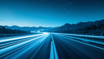 Fototapeta premium Long exposure night shot of a multi-lane highway with bright blue light trails from moving vehicles, winding through mountains under a starry sky