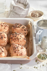 Warm and golden pumpkin seed rolls, just baked in kitchen.