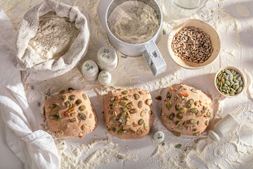 Homemade, golden pumpkin rolls displayed on a rustic wooden table.