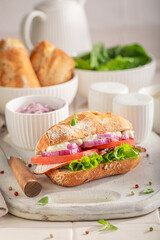 A nutritious and fresh sandwich with chicken, tomatoes, and lettuce.