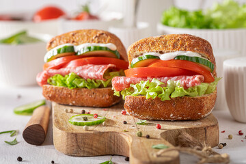 Healthy sandwich prepared with salami, vegetables, and hint of mayonnaise.