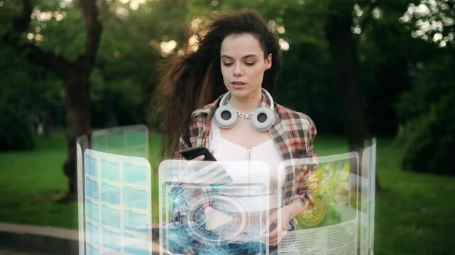 A young woman walks through a park while interacting with a futuristic holographic interface. Digital elements display maps, media, and data around her. Advanced augmented reality technology
