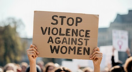 Sign stating "Stop Violence Against Women" held at protest