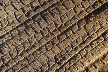 car wheel tracks on wet ground, bad road