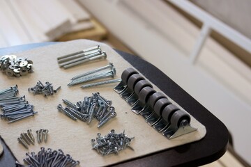 Set of fasteners for assembling an ottoman. Laid out for convenience. Close-up view.