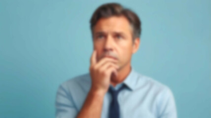 Fototapeta premium Blurred background of an individual immersed in creative thought, with a light blue backdrop symbolizing calm inspiration