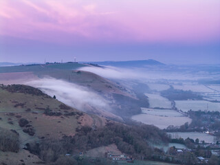 Stunning aerial drone landscape sunrise image of atmospheric cloud inversion over South Downs escarpment