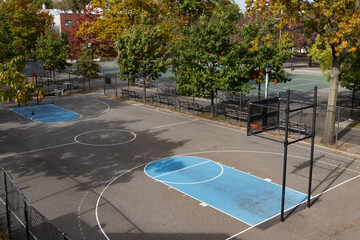 Empty Basketball Court Surrounded by Colorful Trees during Fall in Astoria Queens New York