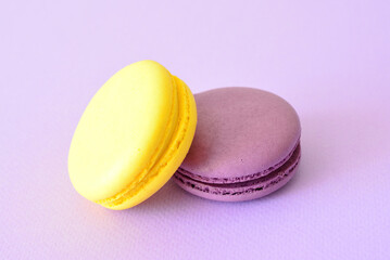 a close up of yellow and purple  Macarons