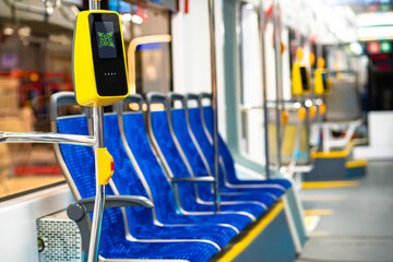 NFC terminal on bus. Device for accepting payments with QR code. Wireless validator for fare payment. Bus interior. Payment for services via QR. Contactless payment acceptance in public transport