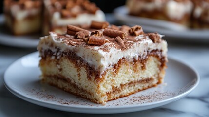 Indulgent slice of cake atop a pristine white plate, adorned with smooth white frosting and sprinkled with luxurious chocolate shavings. 