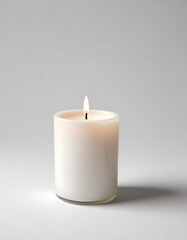 Lit White Candle with Green Leaves on a Minimal Background