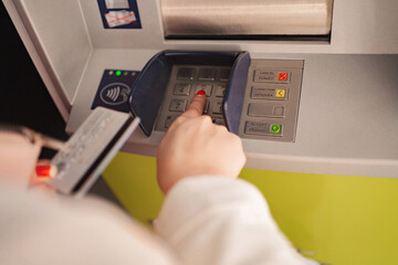 Using an ATM to withdraw cash in a modern urban setting