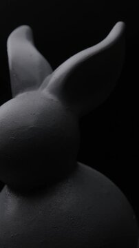 Vertical shot of bunny figure. Abstract concept of rotation. Easter concept  