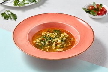 Vibrant Chicken Noodle Soup in Coral Bowl A Study in Warm Tones and Rustic Elegance