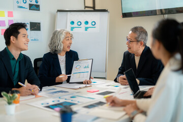 Business professionals analyzing financial data at conference table