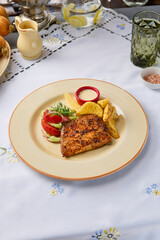 Grilled Trout with Baked Potatoes and Vegetable Salad on Elegant Floral Tablecloth