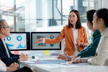 Business team analyzing financial charts and graphs showing company growth and success