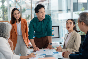 Group of asian businesspeople working together in the office analyzing financial charts