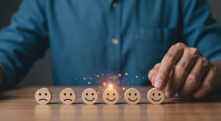 Achieving Ultimate Customer Satisfaction, A Hand Carefully Selects A Happy Face Among Wooden Emotion Icons, Glowing With Positive Energy And Warm Light