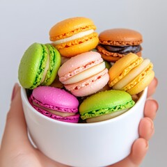Stylish cup filled with exquisite macarons in assorted colors for a beautifully arranged gourmet treat presentation