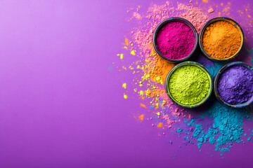 Happy holi festival decoration.Top view of colorful holi powder on purple background with copy space for text.