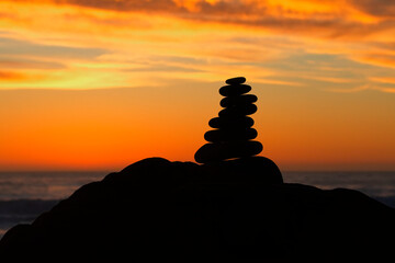 Stacked stones at sunset create sense of harmony and stability at Cambria, California