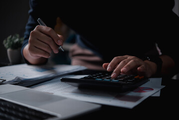 Businessman using calculator bookkeeping payroll and budget tax. Business document finance...