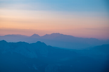 Silhouettes of mountains in a beautiful gentle haze, mountains at sunset or sunrise, natural background