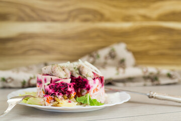 Festive layered salad with herring, beetroot and mayonnaise