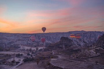 Early morning view of hot air balloons rising up in Cappadocia, Turkey