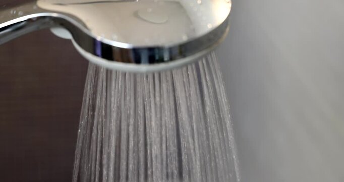 Aerial Video of Flowing Water from a Showerhead and Hands Under Running Water