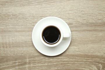 Cup of coffee on wooden background