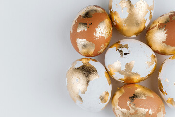 Close up of golden Easter eggs top view, place for a text. Easter background.