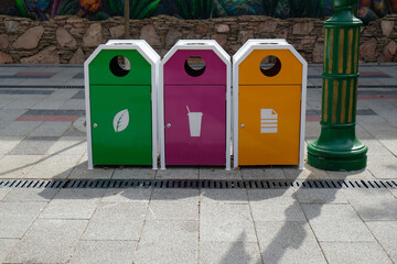 multi-colored bins for separate waste collection on the city street