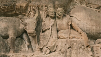 Dazu：A series of Chinese religious sculptures and carvings and UNESCO World Heritage Site located in Dazu District, Chongqing, China. The carvings date back as far as the 7th century AD