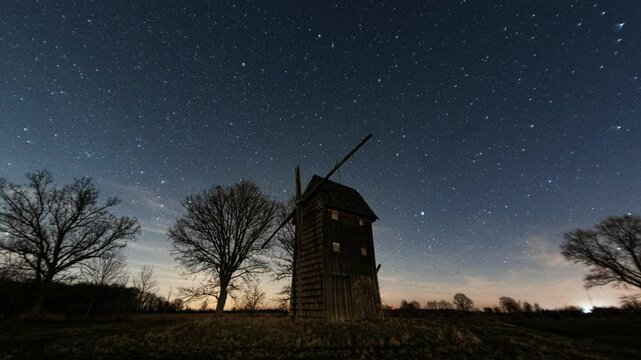 An old wooden windmill against the night sky