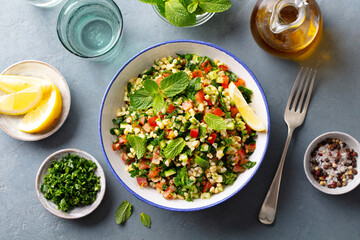 Tabbouleh salad in a bowl. Grey background. Close up. Top view.