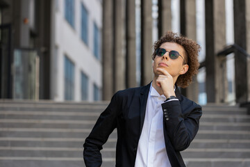 Portrait of Caucasian puzzled businessman professional standing outdoors deep in thoughts thinking...