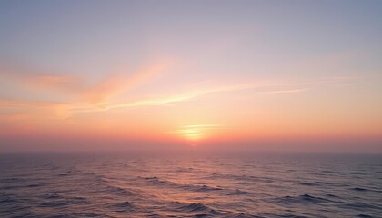 Pastel sunrise over calm ocean, misty horizon, pink, soft hues
