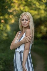 Portrait of a young beautiful blonde girl outdoors. Black and white photo.