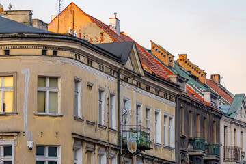 old urban architecture at sunset. blocks and residential buildings in the city against the background of a beautiful sky. renovated residential tenement houses.