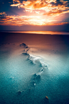 Polypropylene Woven sack buried in the sand on a beach at sunset, Lithuania