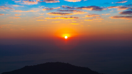 Obraz premium Sunrise time. morning time over the mountain with blue and orange sky. warm tone.